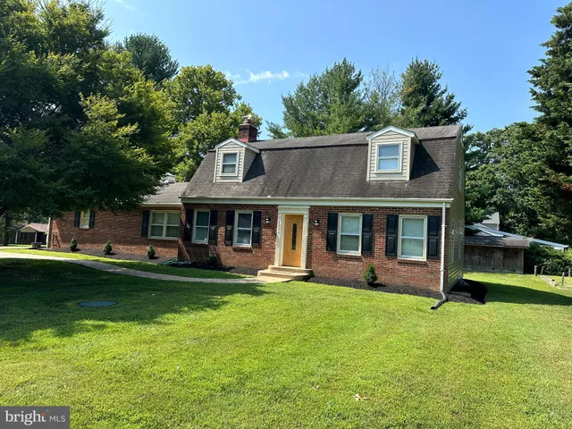 a front view of a house with swimming pool having outdoor seating