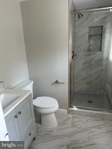 a bathroom with a shower and a toilet