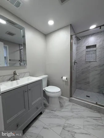 a bathroom with a toilet sink and shower