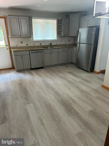 a kitchen with stainless steel appliances a refrigerator sink and cabinets