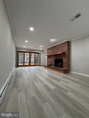 an empty room with a fireplace and window