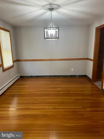a view of a room with window and wooden floor