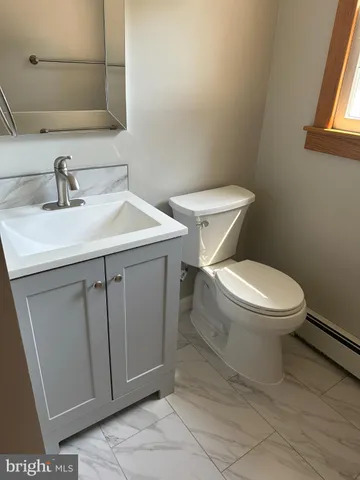 a white toilet sitting next to a bathroom sink
