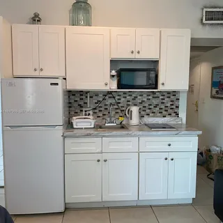 a bedroom with a bed and a night stand