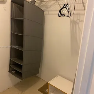 a living room with stainless steel appliances furniture and a flat screen tv