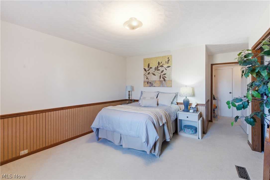 52450 Tower Road Cumberland, OH 43732 - Photo 16 of 41 Carpeted bedroom featuring wainscoting