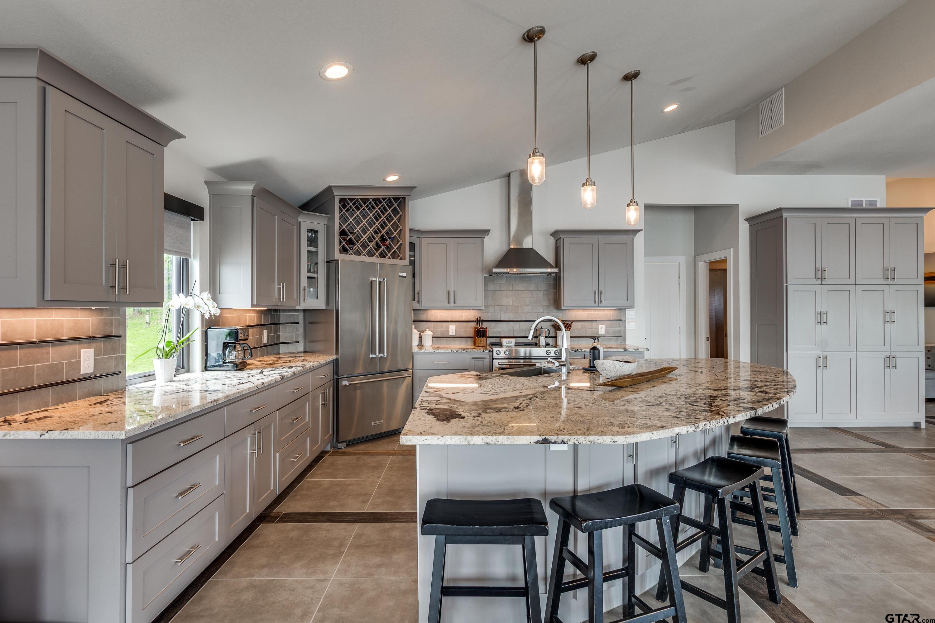 16822 Perry Street Tyler, TX 75707 - Photo 32 of 45 a kitchen with kitchen island granite countertop a table and chairs in it