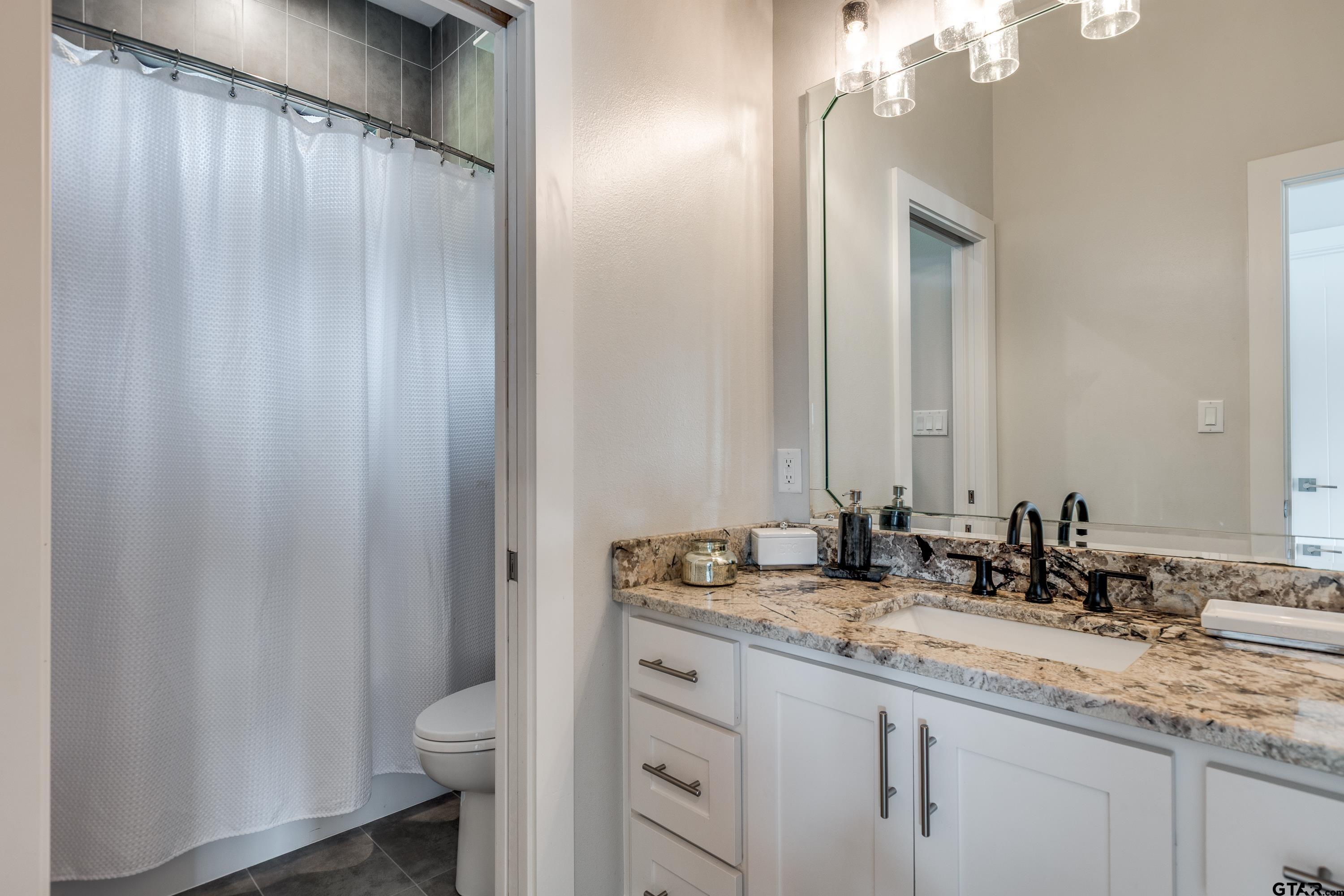 16822 Perry Street Tyler, TX 75707 - Photo 39 of 45 a bathroom with a double vanity sink and a mirror
