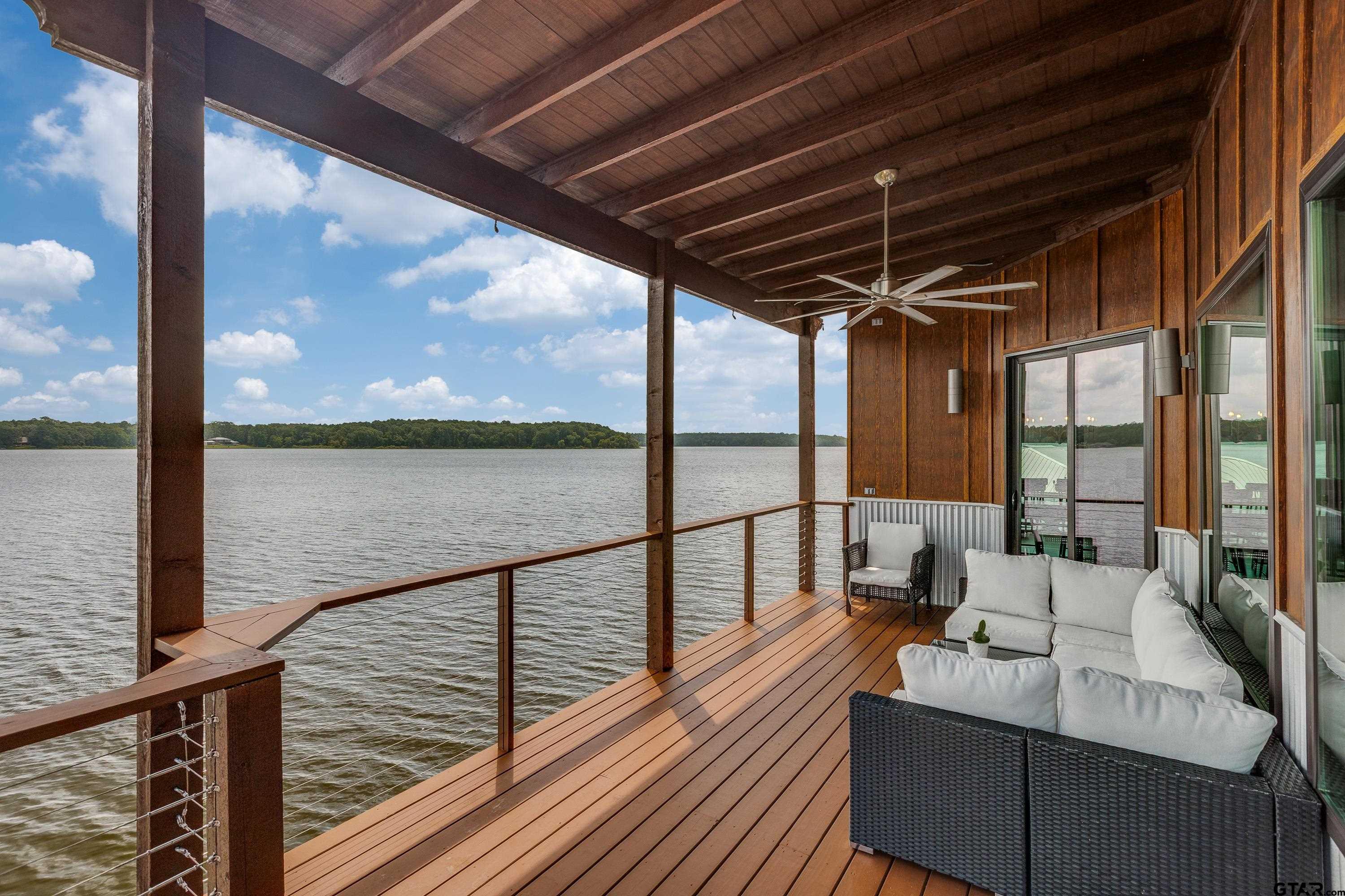 16822 Perry Street Tyler, TX 75707 - Photo 8 of 45 a view of balcony with couches and wooden floor