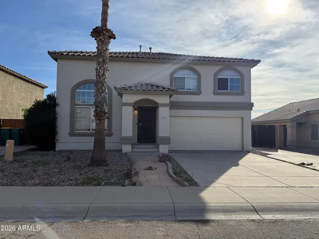 a front view of a house with a yard and garage