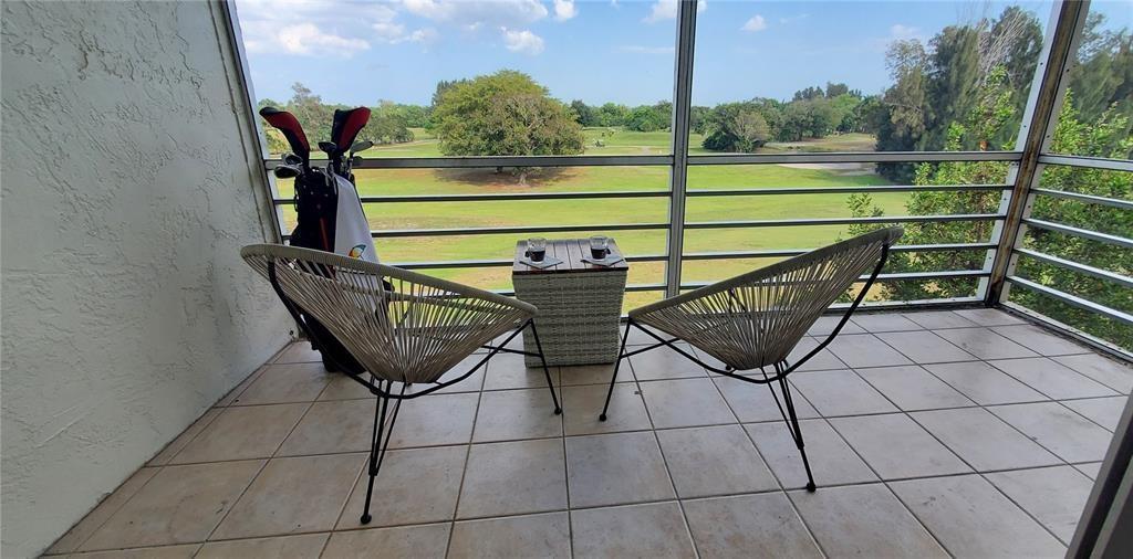 5100 Southwest 90th Avenue, Unit 406 Cooper City, FL 33328 - Photo 1 of 25 a view of a chairs and table on the terrace