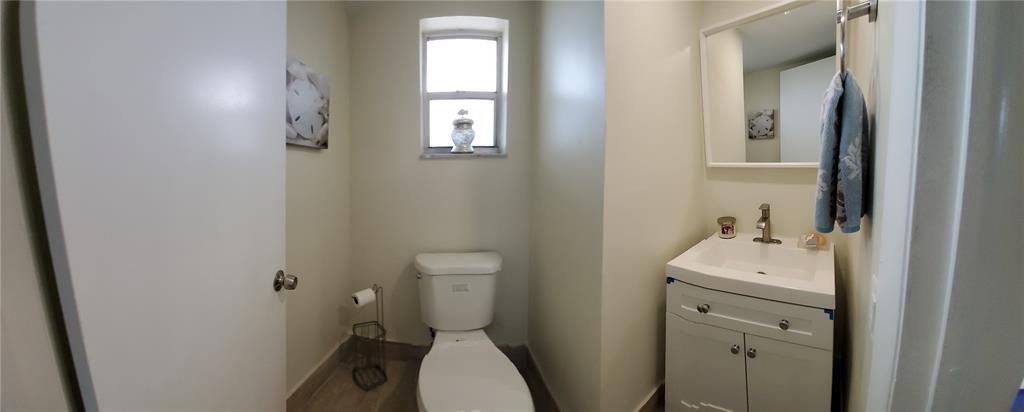 5100 Southwest 90th Avenue, Unit 406 Cooper City, FL 33328 - Photo 11 of 25 a bathroom with a toilet sink and mirror