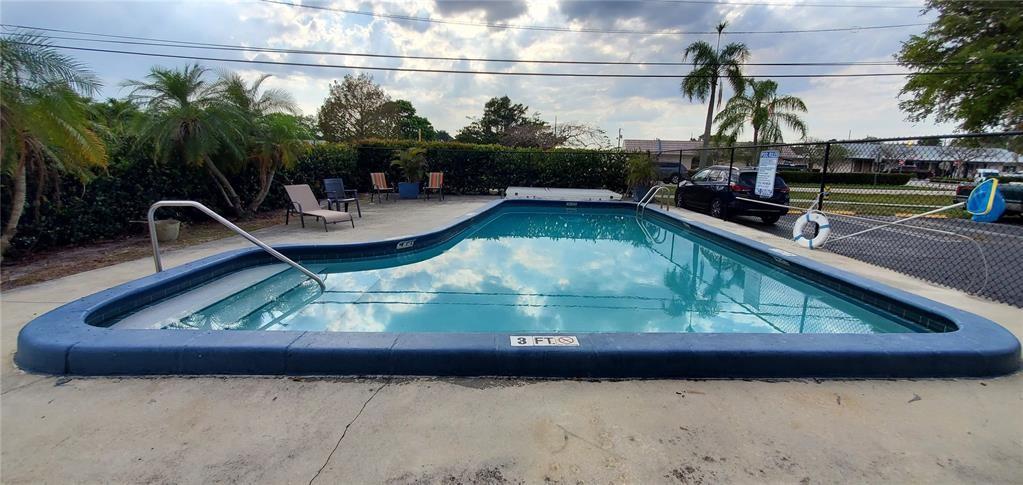 5100 Southwest 90th Avenue, Unit 406 Cooper City, FL 33328 - Photo 12 of 25 a view of swimming pool with a yard and sitting space