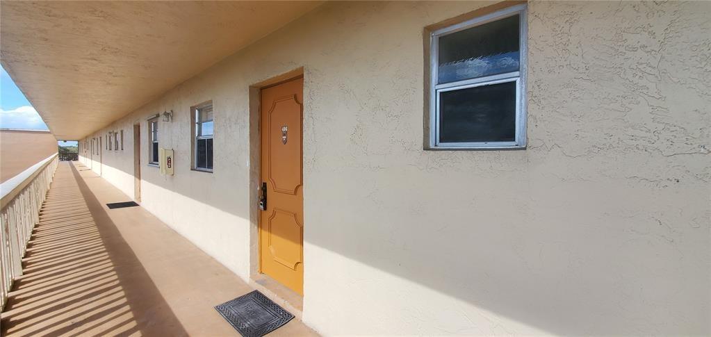 5100 Southwest 90th Avenue, Unit 406 Cooper City, FL 33328 - Photo 15 of 25 a hallway with wooden floor and staircase