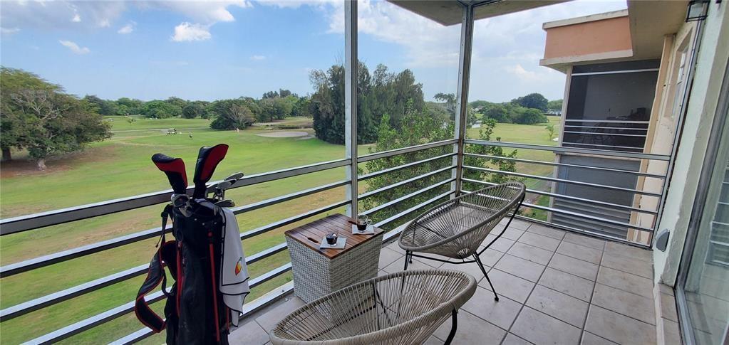 5100 Southwest 90th Avenue, Unit 406 Cooper City, FL 33328 - Photo 16 of 25 a view of a chairs and table in the patio