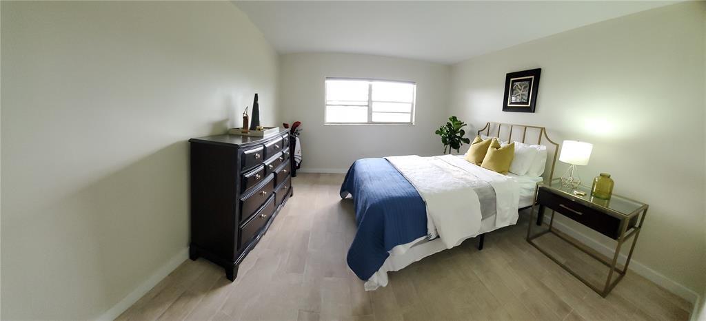 5100 Southwest 90th Avenue, Unit 406 Cooper City, FL 33328 - Photo 5 of 25 a bed room with a bed and a window