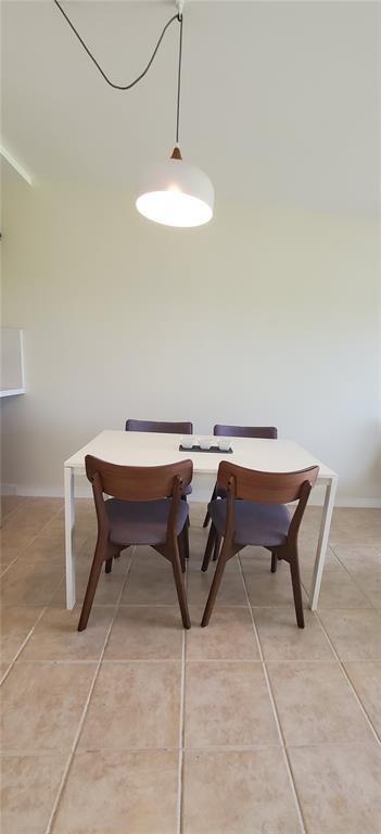 5100 Southwest 90th Avenue, Unit 406 Cooper City, FL 33328 - Photo 10 of 25 a patio with a table and chairs