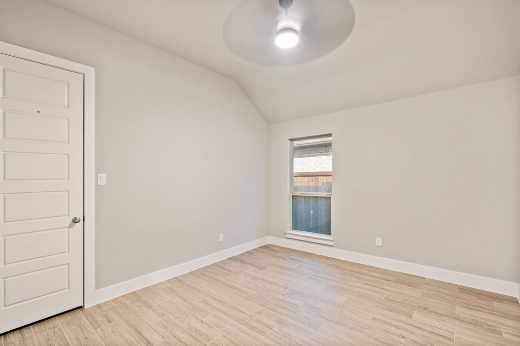 1314 Buttermere Street Forney, TX 75126 - Photo 17 of 32 an empty room with wooden floor and windows