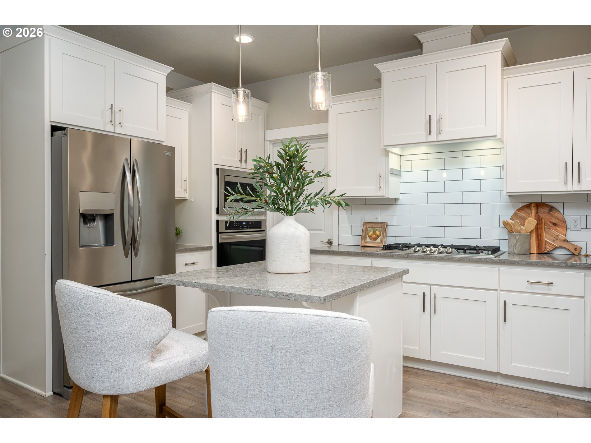 3606 Northeast Oriole Street Camas, WA 98607 - Photo 24 of 48 a kitchen with stainless steel appliances kitchen island granite countertop a refrigerator a sink a dining table and chairs