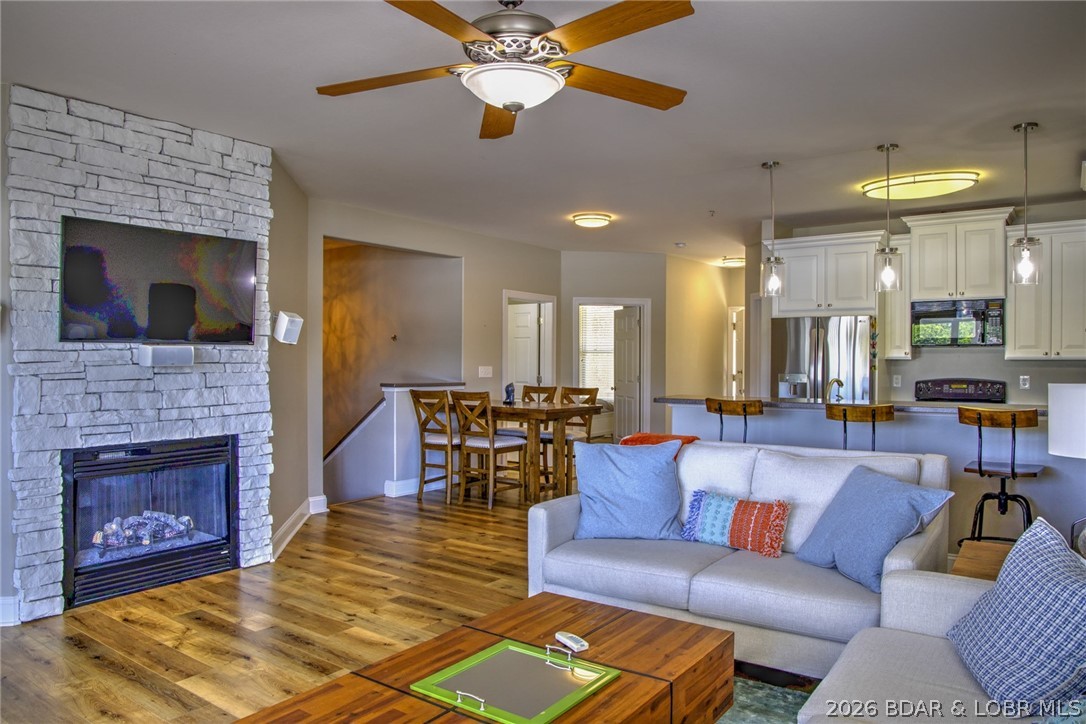 275 Flynn Road, Unit 106 Lake Ozark, MO 65049 - Photo 1 of 39 Mixture of warm wood tones along with stone firepl