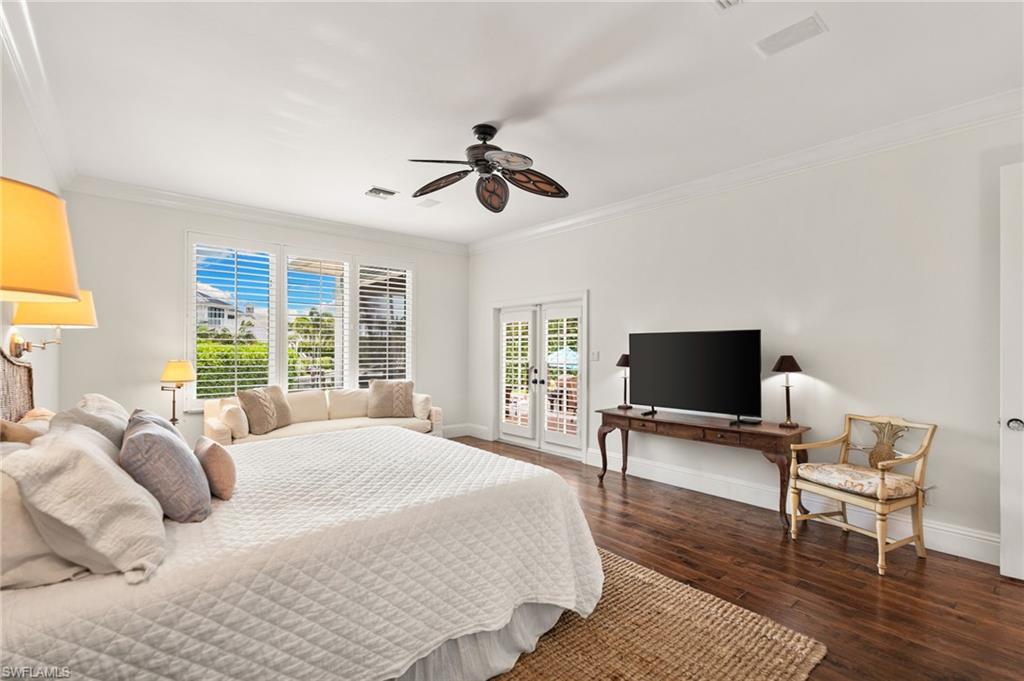 2201 Beacon Lane Naples, FL 34103 - Photo 8 of 25 a bedroom with a bed and a flat screen tv