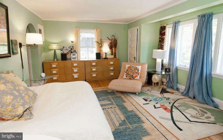 8 St Johns Road Baltimore, MD 21210 - Photo 11 of 18 a bedroom with a bed couch and a flat tv screen