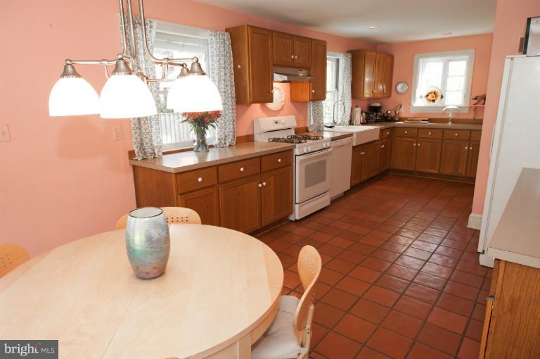 8 St Johns Road Baltimore, MD 21210 - Photo 7 of 18 a kitchen with a sink a stove cabinets and dining table