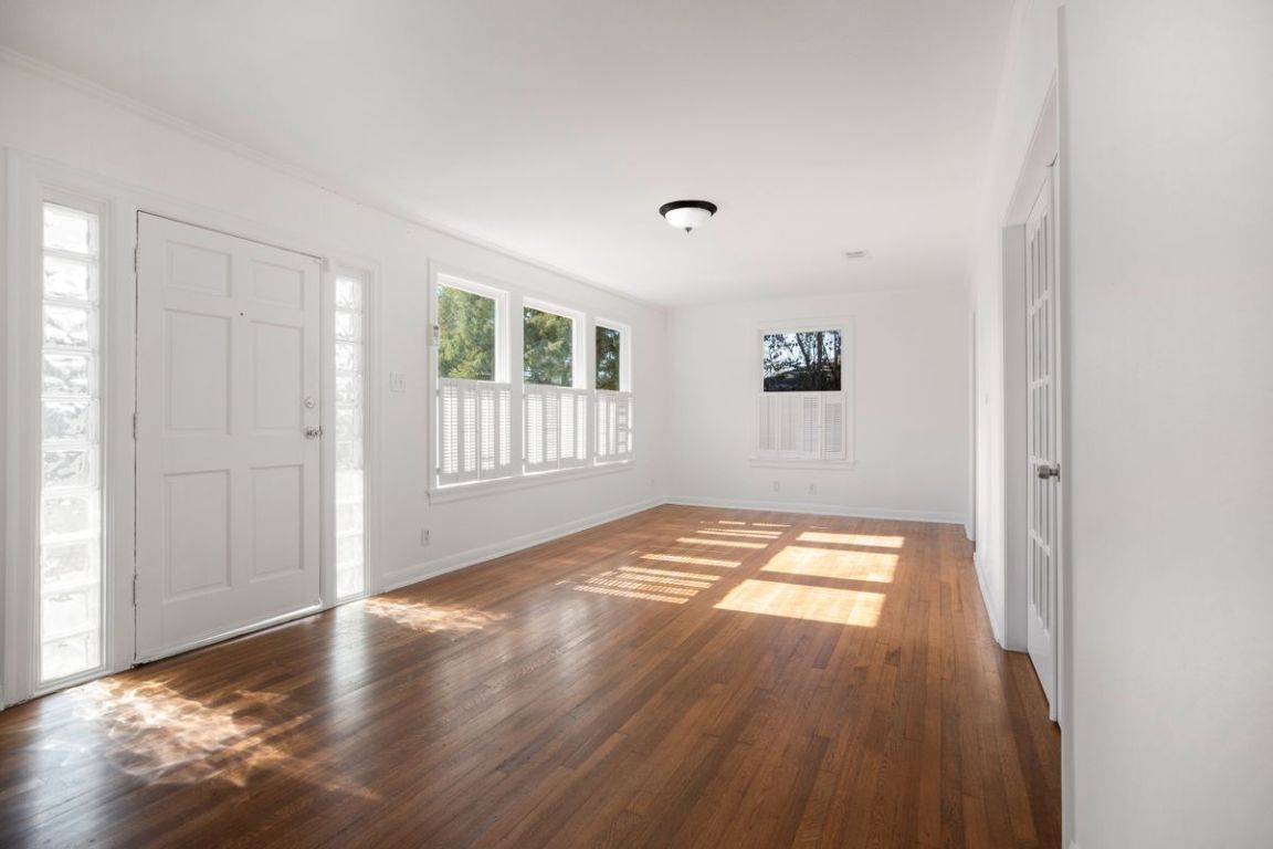 1704 Northwood Road Austin, TX 78703 - Photo 4 of 22 a view of empty room with wooden floor and fan