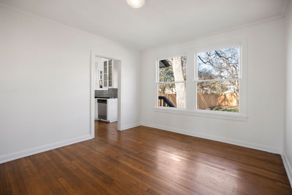 1704 Northwood Road Austin, TX 78703 - Photo 5 of 22 an empty room with wooden floor and windows
