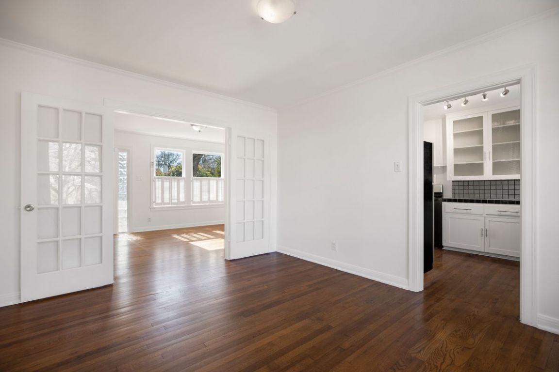 1704 Northwood Road Austin, TX 78703 - Photo 6 of 22 wooden floor in an empty room with a window