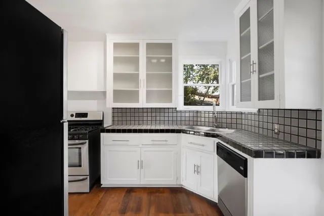 a kitchen with a sink stove and cabinets