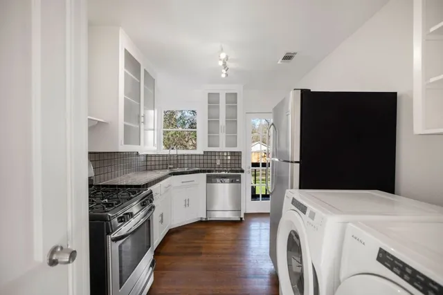 a kitchen with a stove and a refrigerator