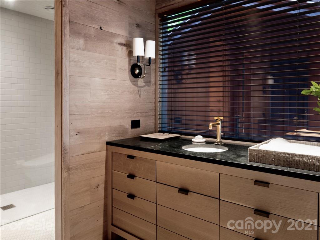 318 Summer Haven Lane Saluda, NC 28773 - Photo 17 of 40 a bathroom with a granite countertop sink and a mirror