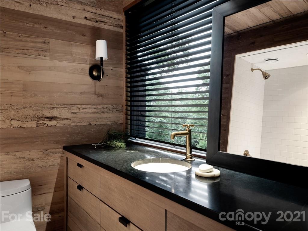 318 Summer Haven Lane Saluda, NC 28773 - Photo 18 of 40 a bathroom with a granite countertop sink and a mirror