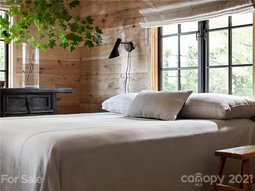 318 Summer Haven Lane Saluda, NC 28773 - Photo 19 of 40 a bedroom with a bed and a potted plant