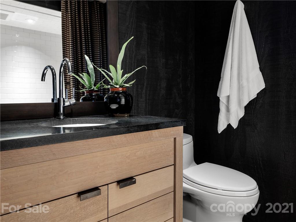 318 Summer Haven Lane Saluda, NC 28773 - Photo 22 of 40 a bathroom with a toilet sink and mirror