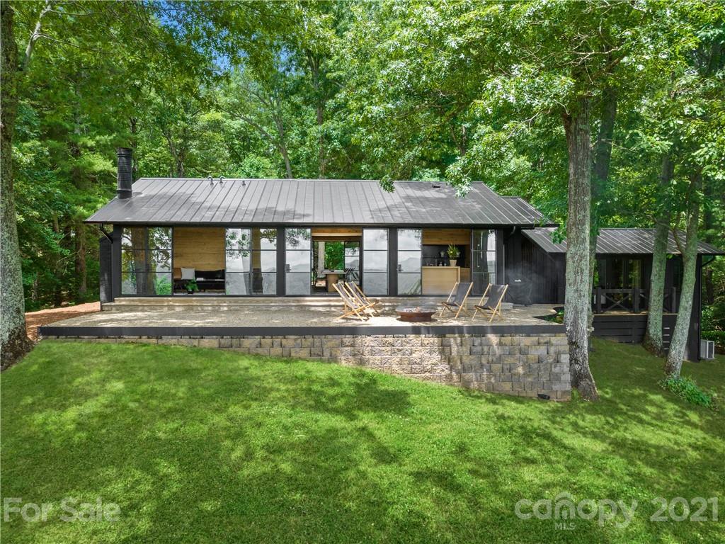 318 Summer Haven Lane Saluda, NC 28773 - Photo 27 of 40 a front view of a house with a yard table and chairs