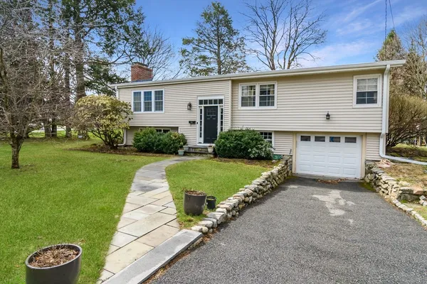 a view of a house with a yard and tree s