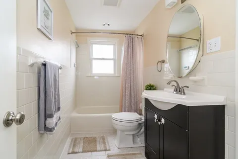 a bathroom with a sink toilet a mirror and shower