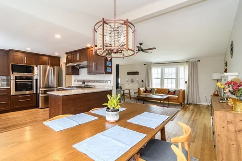 a kitchen with a dining table and chairs