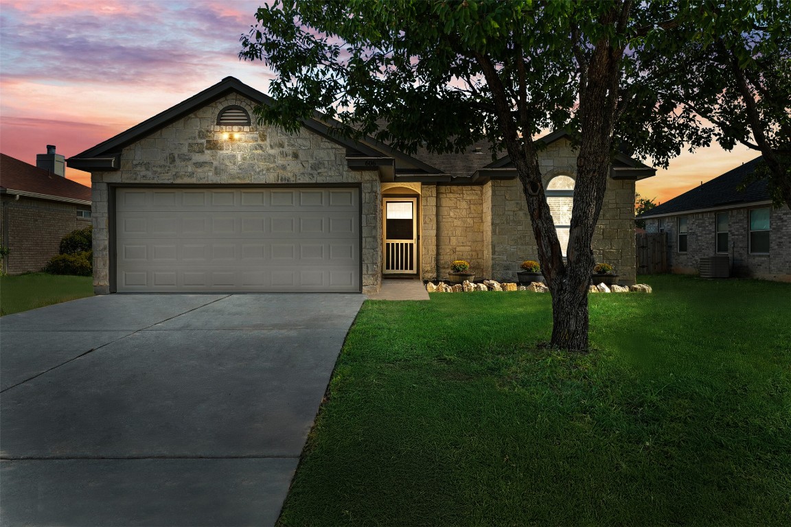 a front view of a house with a yard and garage