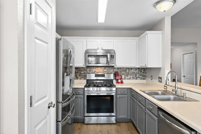 a kitchen with a stove and a sink
