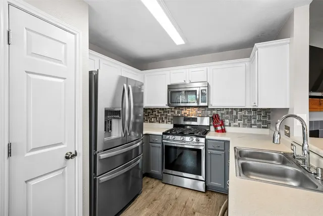 a kitchen with a refrigerator stove and sink