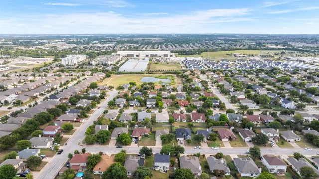 an aerial view of residential houses with outdoor space