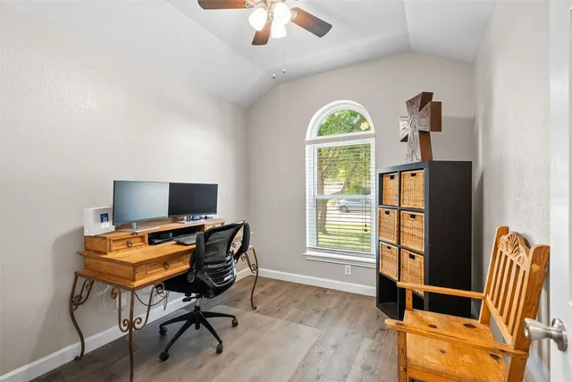 a view of a workspace with furniture and a window
