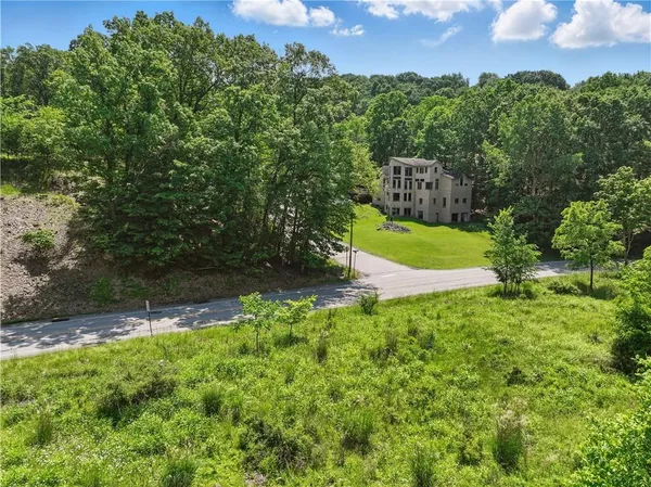 a view of a garden with a building in the background