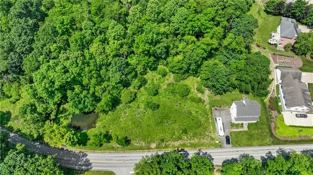 an aerial view of a house with yard