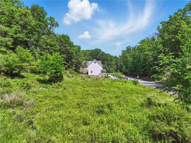 a aerial view of a house with yard and outdoor seating
