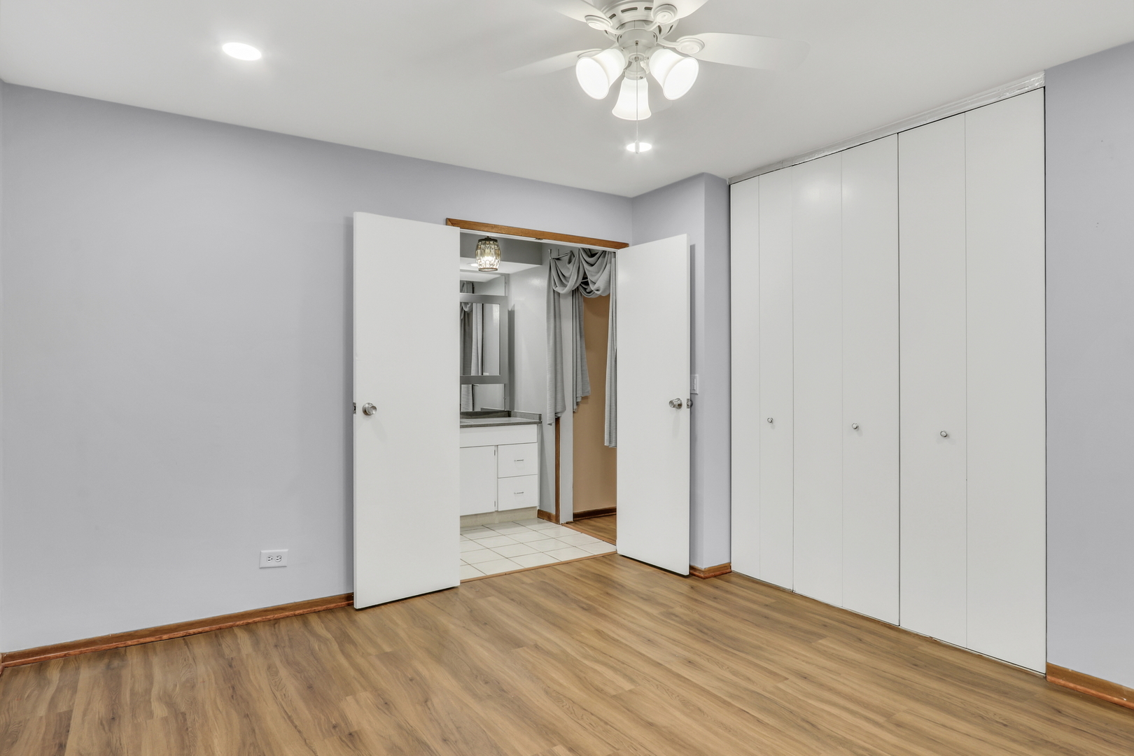 8620 Waukegan Road, Unit 107 Morton Grove, IL 60053 - Photo 11 of 18 a view of an empty room with wooden floor