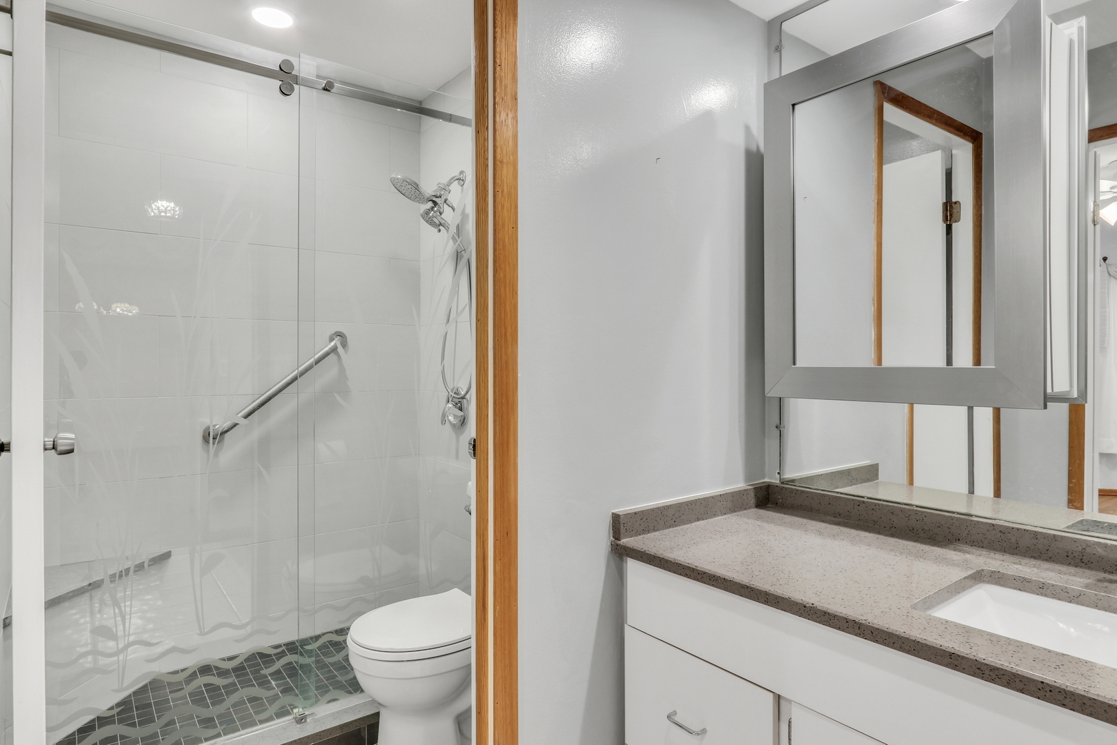 8620 Waukegan Road, Unit 107 Morton Grove, IL 60053 - Photo 13 of 18 a bathroom with a granite countertop sink toilet and shower